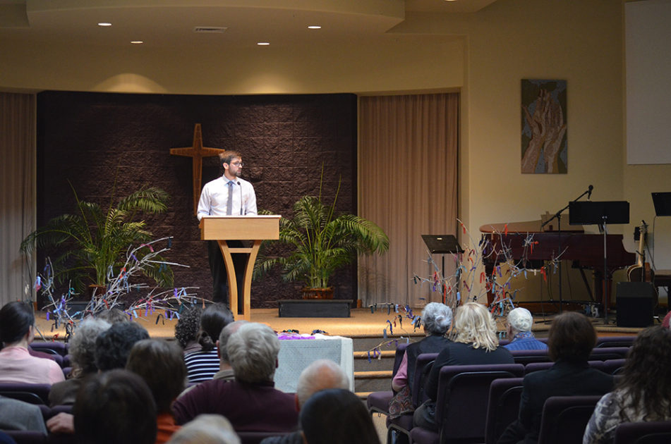 Pastor Jordan standing on the stage during Lent speaking to the congregation.